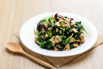 Stir fried Thai spinach with egg on white dish with spoon ready to eating, Healthy Thai food