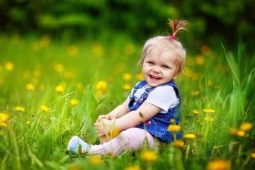 girl child walks in the garden in spring, cherry blossoms, blooming, may