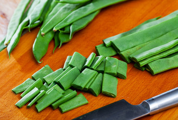 Sliced green beans on a wooden board