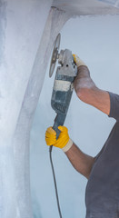 worker cutting stone with grinder