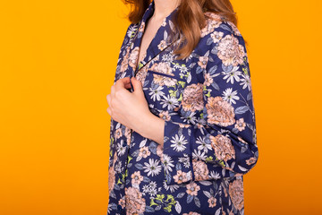 Close up of woman with curly hair in home wear pajama. Isolated on yellow background.