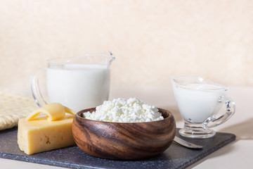 Food is a source of calcium, magnesium, protein, fats, carbohydrates, balanced diet. Dairy products on the table: cottage cheese, sour cream, milk, cheese, contain casein, albumin, globulin, lactose