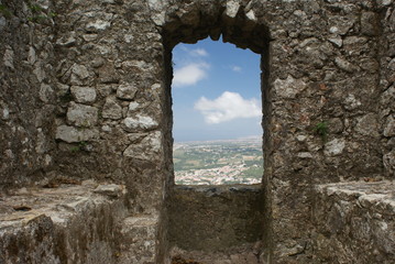 distant landscape through hole in stone wall
