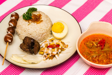Indonesian traditional food nasi liwet with empal daging, tahu, sambal and lalapan served with rice and assorted vegetables