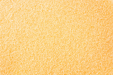 Heap of cane sugar. Top view. Background of brown sugar. Dark sugar background. Sugar for cooking. Selective focus.