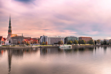 Skyline of Riga and the river Daugava in the morning,  Latvia.  St. Peter's Church (left). Delicate pink morning