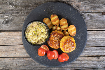 Fish cutlet on a black stone plate