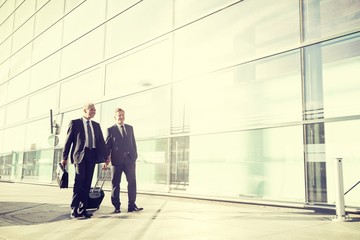 Portrait of businessmen walking in airport