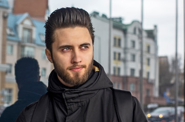 Handsome serious confident portrait of a young man on the street