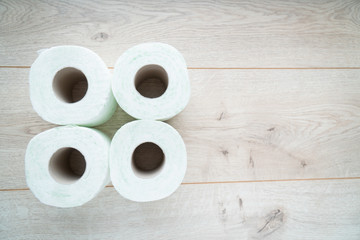 Rolls of toilet paper on wooden background