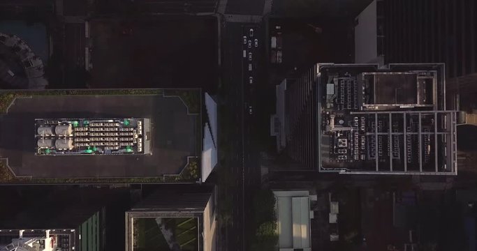 Bird's eye view aerial flight over high rise buildings following traffic line. Drone, 4K.