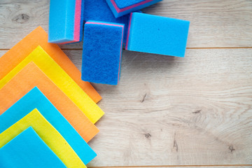  Kitchen rags and sponges on a wooden background