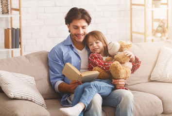 Daddy and daughter reading funny stories together