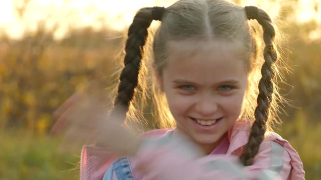 Portrait of cute little girl in Park on sunset. It keeps off mosquitoes and midges that bite it