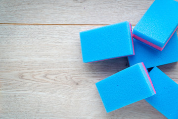  Kitchen rags and sponges on a wooden background