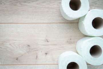 Rolls of toilet paper on wooden background
