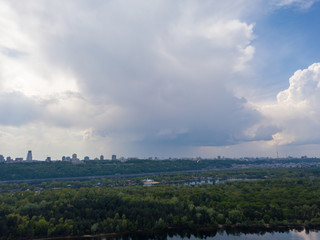 Obraz premium Rain clouds over the Dnieper River in Kiev. Aerial drone view.