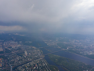 Spring rain over Kiev. There are black thunderclouds in the sky, dark rain falls on the city. Aerial drone view.