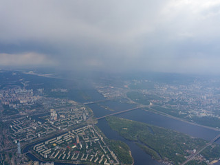 Spring rain over Kiev. There are black thunderclouds in the sky, dark rain falls on the city. Aerial drone view.