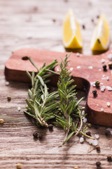 Rosemary herbs close-up on cutting board background.