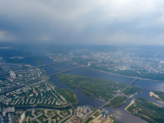 Spring rain over Kiev. There are black thunderclouds in the sky, dark rain falls on the city. Aerial drone view.