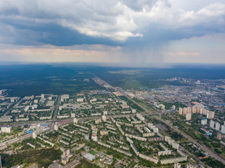 Spring rain over Kiev. There are black thunderclouds in the sky, rain is falling on the city. Aerial drone view.