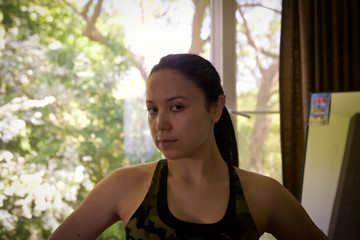 Strong latina woman ready for working out at home