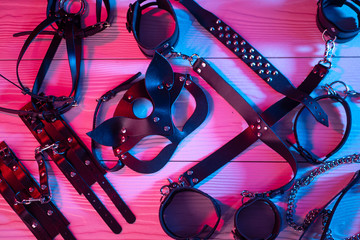 Set of erotic toys for BDSM. The game of sexual slavery with a whip, gag and leather blindfold....