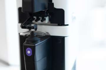 Glasses Manufacturing Process. Optician polishing glasses in optical shop