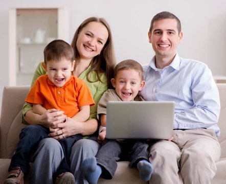 Young family surfing internet and looking at photos