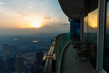 Sunset top view city with modern hotel balcony. Background for Dubai travel and relaxation