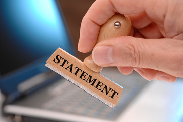 statement  printed on rubber stamp in hand