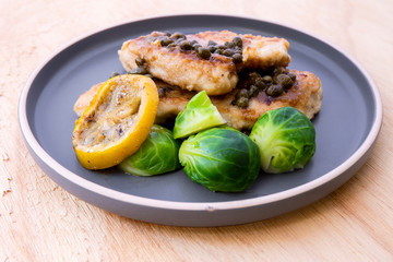 Italian food Lemon chicken Piccata  with Brussels Sprouts