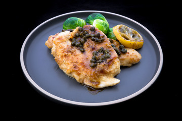 Italian food Lemon chicken Piccata  with Brussels Sprouts
