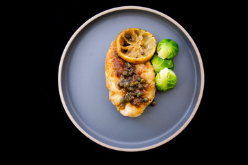 Italian food Lemon chicken Piccata  with Brussels Sprouts