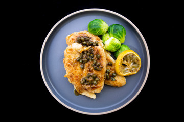 Italian food Lemon chicken Piccata  with Brussels Sprouts
