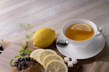 Cup of tea with lemon on wooden table