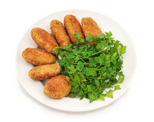 Fresh meat fried cutlets with greens on a plate.