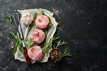 raw pork tenderloin medallions with spices for barbecue. Top view. Free space for your text.