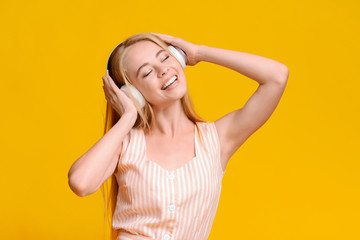 Favorite Leisure. Cheerful Teen Girl In Wireless Headphones Listening Music