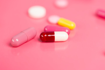 Different medications. Various pill and capsules. One-color backdrop.