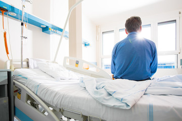 Senior male patient in a modern hospital. Getting better after a surgery/illness (shallow DOF;...