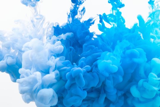 Blue and white paint poured in the liquid, that can be used as abstract wallpaper