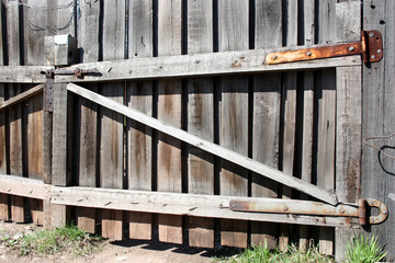 Rural gate made of old bleached wood.