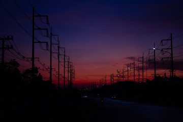 High-voltage electricity poles at sunset in the Lugansk region in the evening.