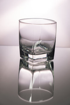 Glass of whiskey on mirroring table. Vertical image with copy space.