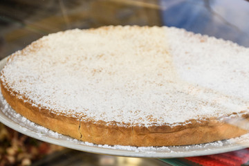 Apple pastry tarte tatin, french dessert with powdered sugar on top