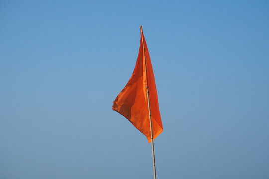 Red Warning Flag At The Beach. Sign Prohibiting Swimming In This Place