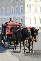 Fototapeta na wymiar Two horses and red carriage