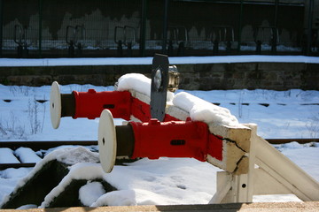 Train buffers, red, covered in snow